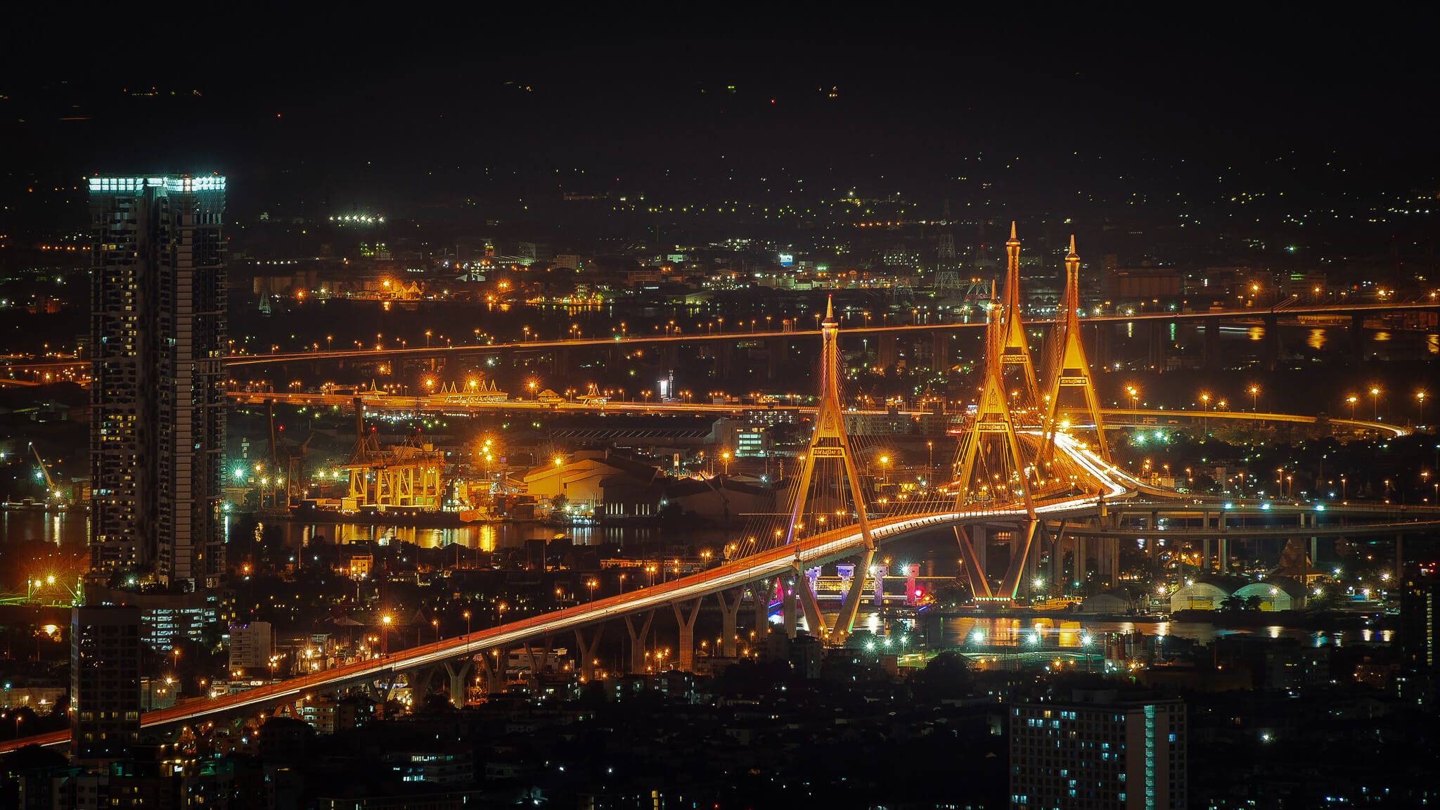 Aerial view of illuminated buildings in Bangkok at night